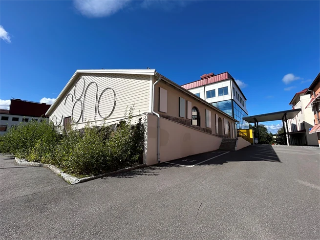 White building with art on the walls. 