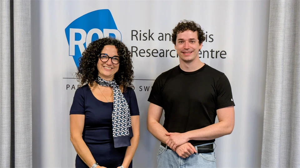 A woman and a man smiling at the camera