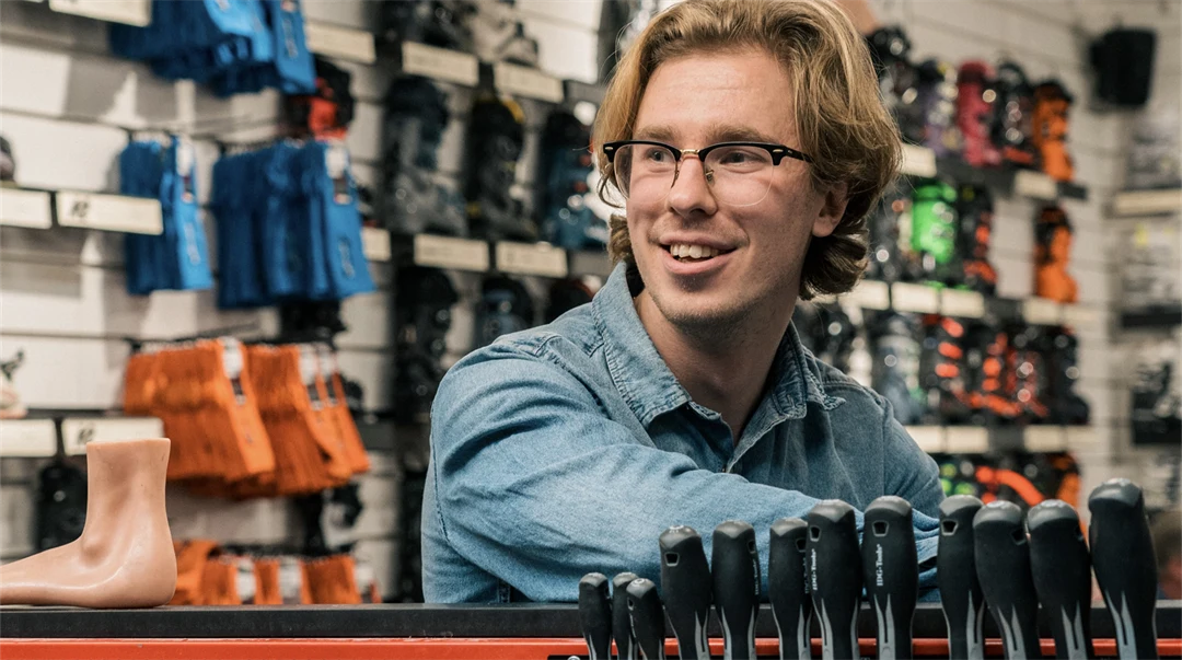 Kille i butiksmiljö med skidartiklar i bakgrunden