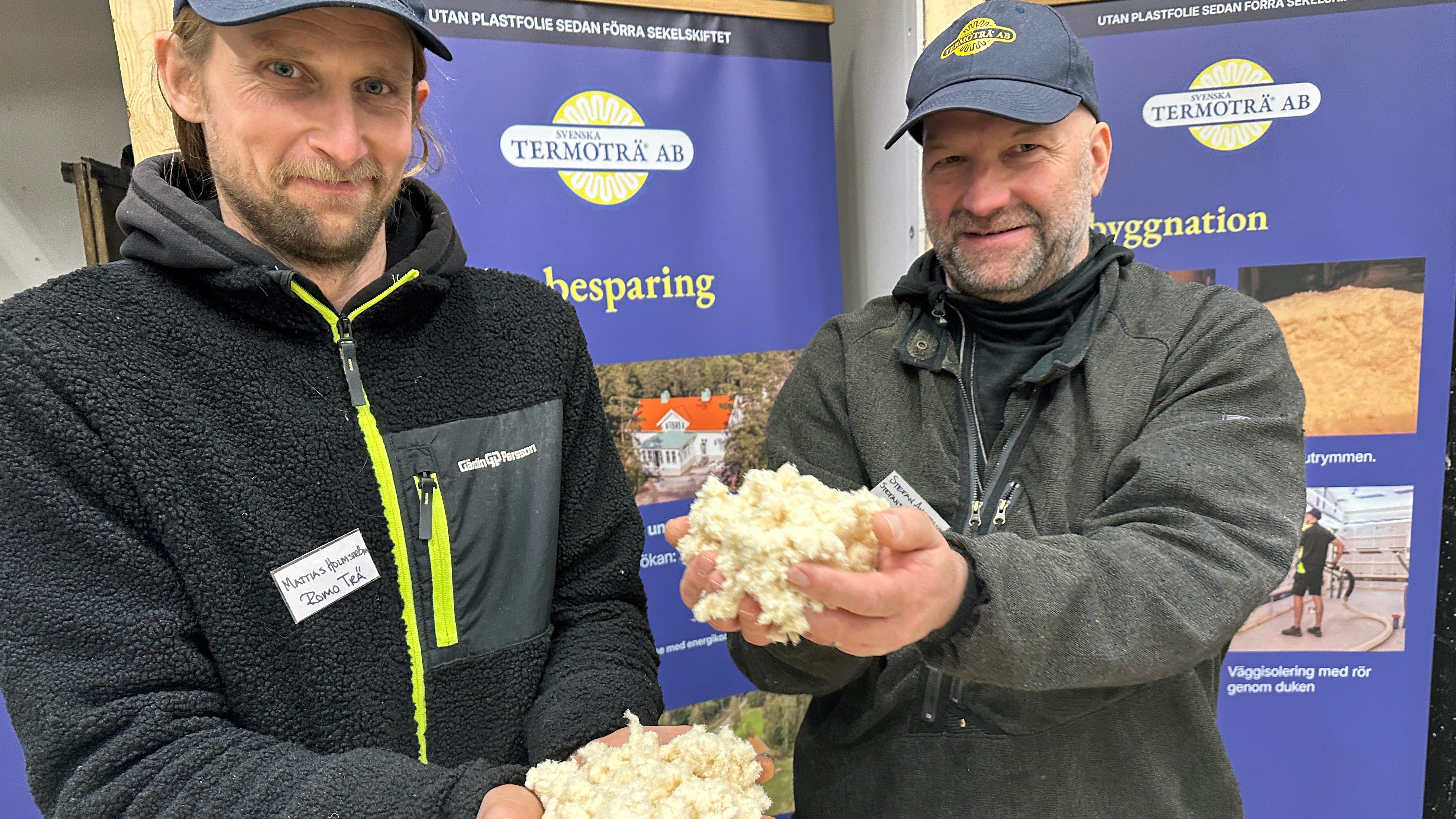 två män håller träfiberull i sina händer