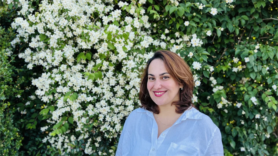 A woman with brown hair and a blue shirt