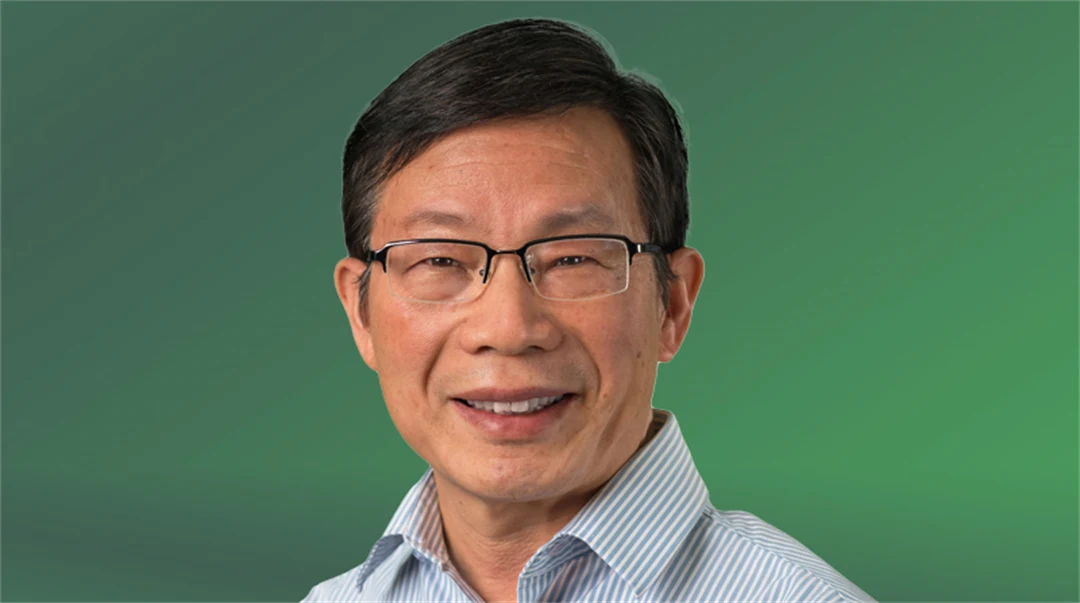  A man with glasses looks into the camera.