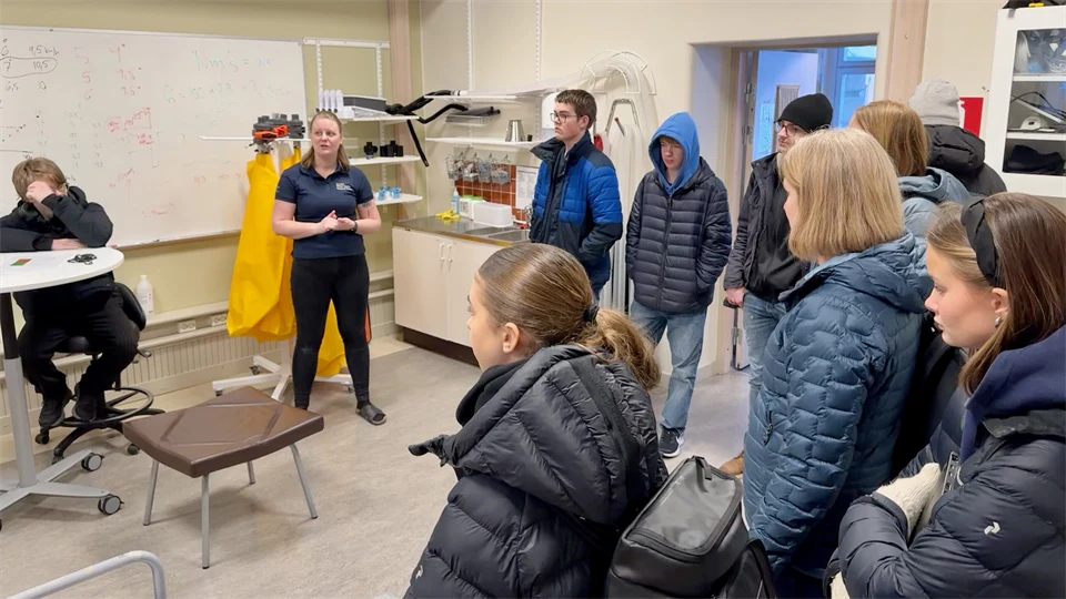 Several people in a testing lab for physical tests.
