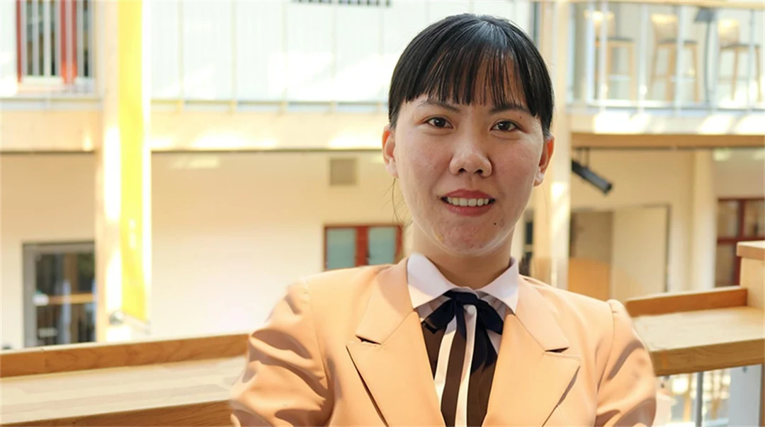 Asian woman posing in front of the camera.
