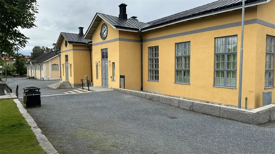 A yellow house with a clock above the entrance.