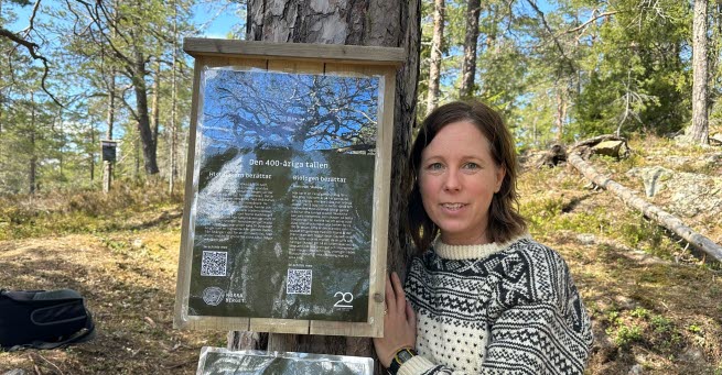 The researcher Jennie standing beside a tree.
