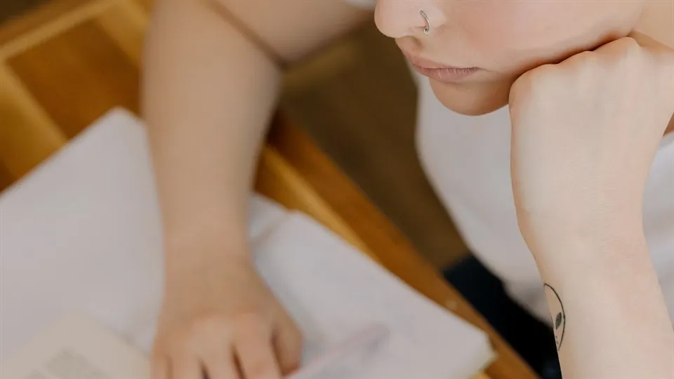 A woman studying by a desk