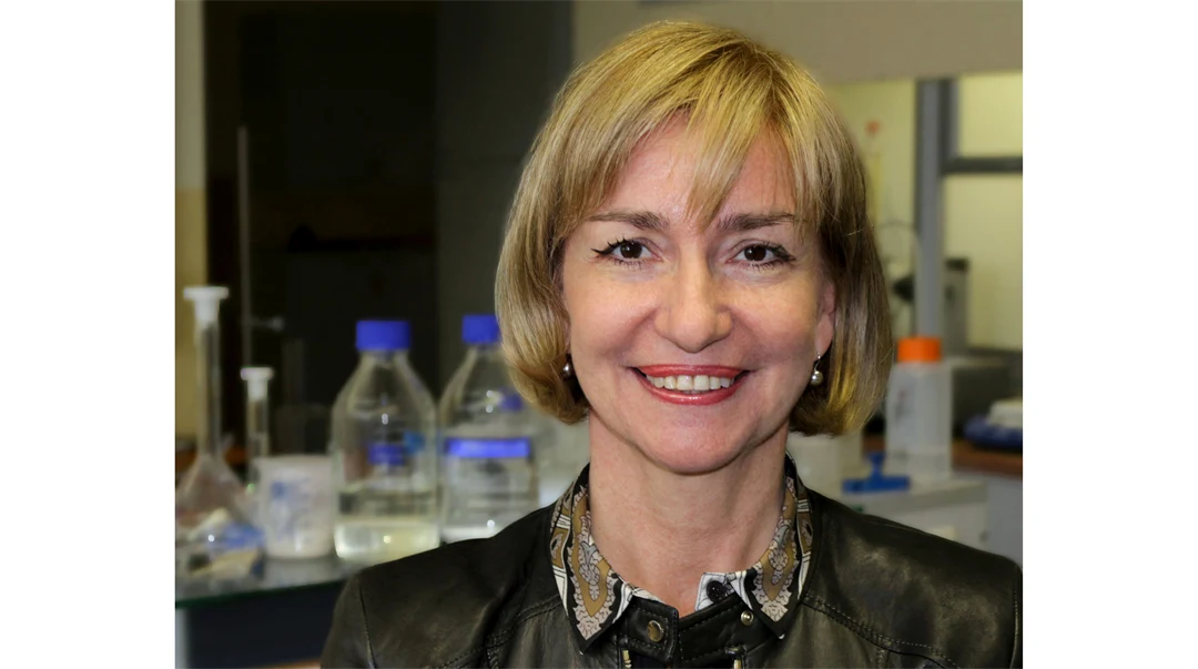 A woman with blond hair, dressed in a shirt and jacket.