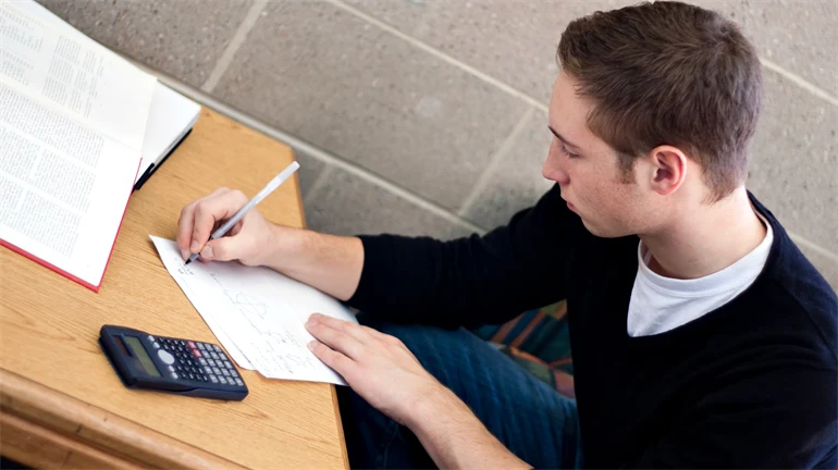 Student sitting and doing math.