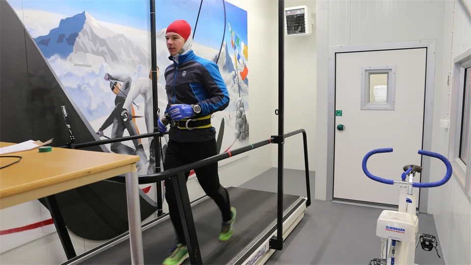 Winter dressed man on treadmill indoors