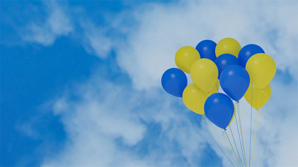 Gula och blå ballonger mot en blå himmel