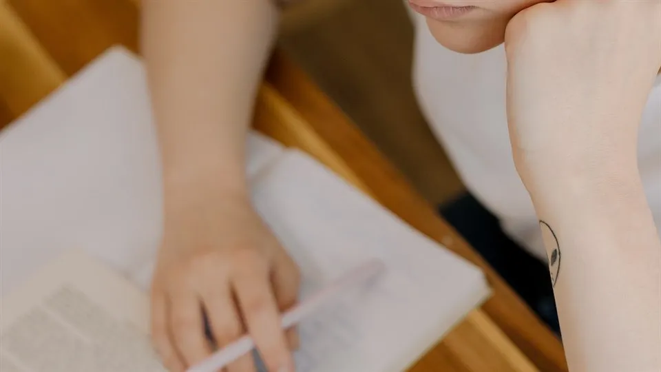 A woman studying by a desk