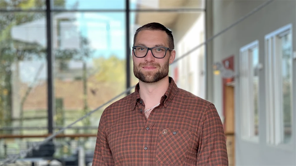 A man looks into the camera and smiles