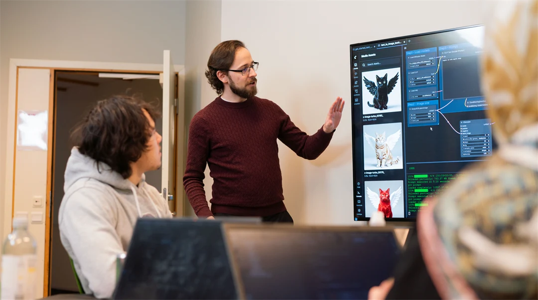 A man stands at a screen and teaches. The screen shows AI code.