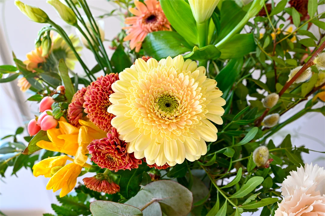 A bunch of flowers in the colors of green, yellow and pink