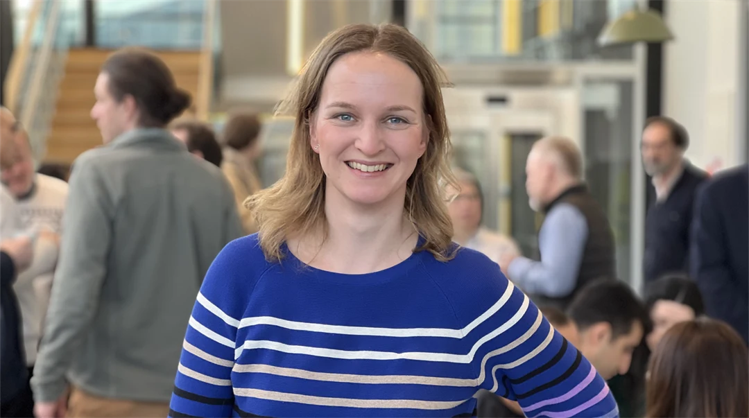  A smiling woman looks into the camera.