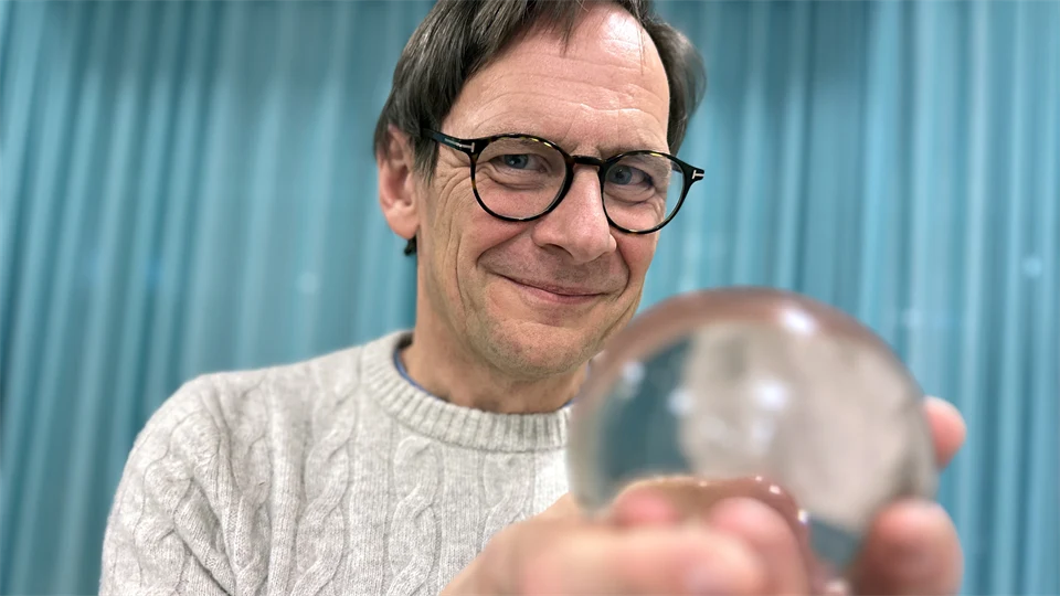 a man holding a crystal bowl
