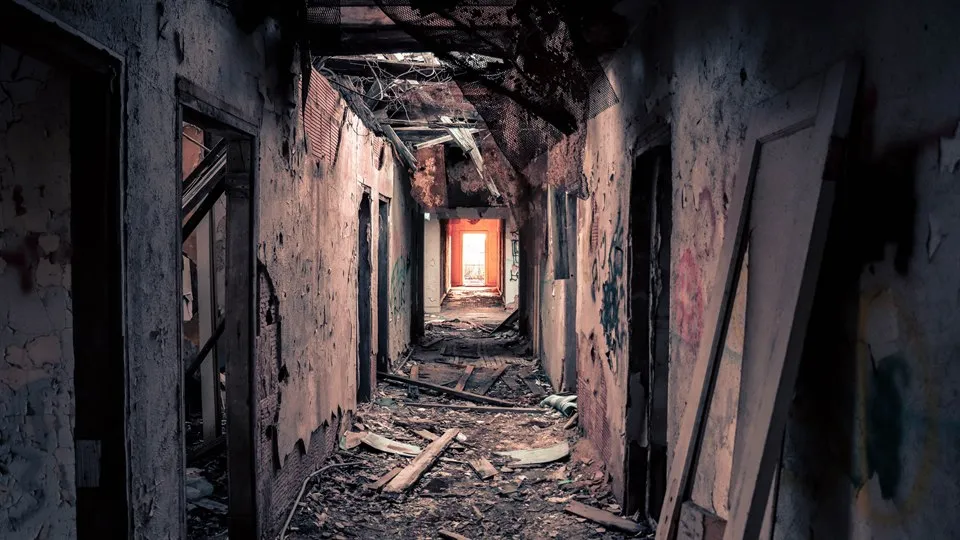 The inside of an abandoned, trashed building.  
