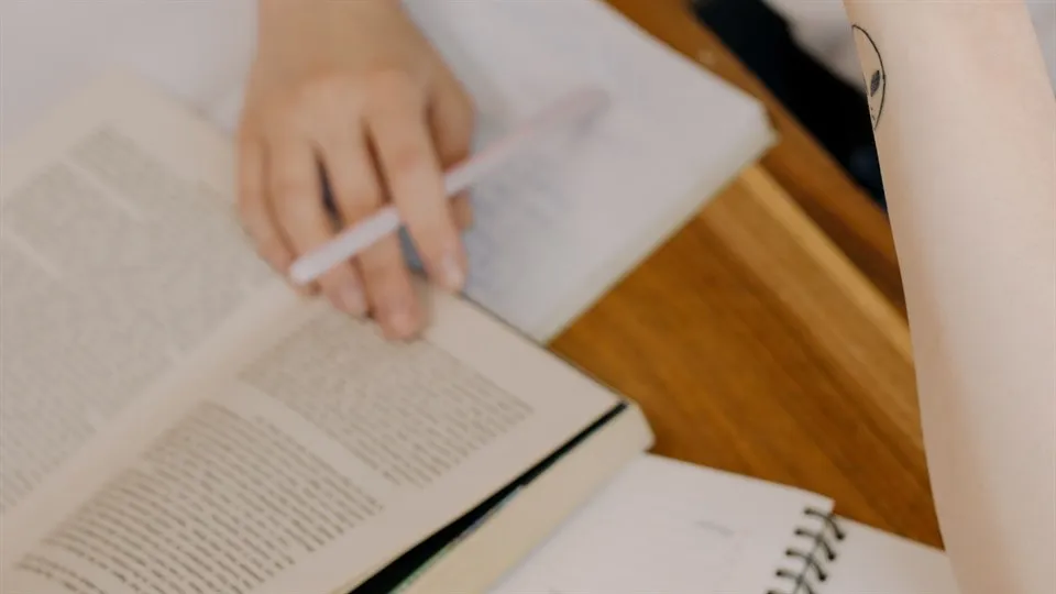 A woman studying by a desk