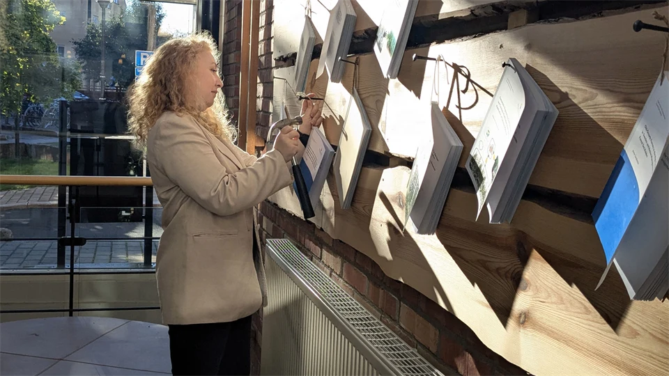 woman standing by a notification board