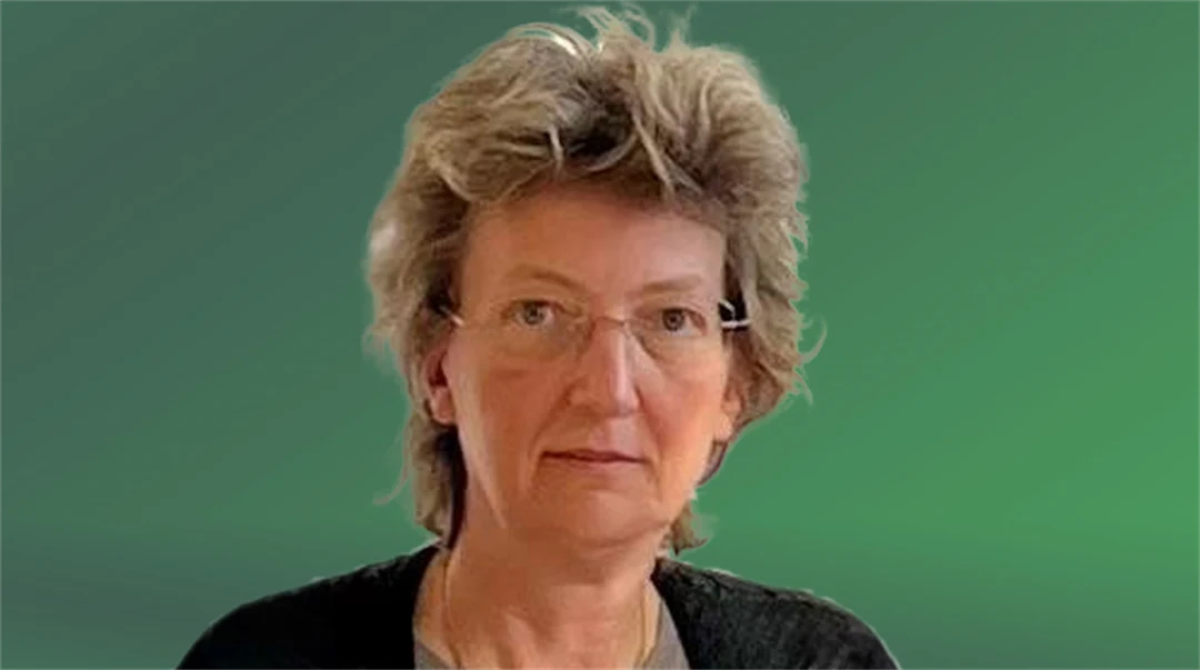  A portrait of a woman, against a green background.