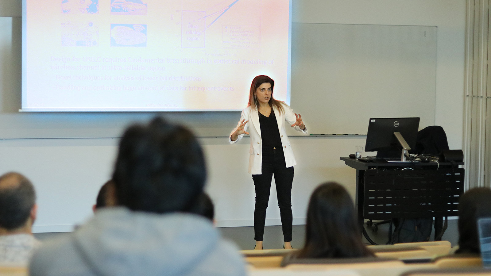 Professor Sinem Coleri giving a presentation on reliable AI and 6G networks to an audience at Mid Sweden University.