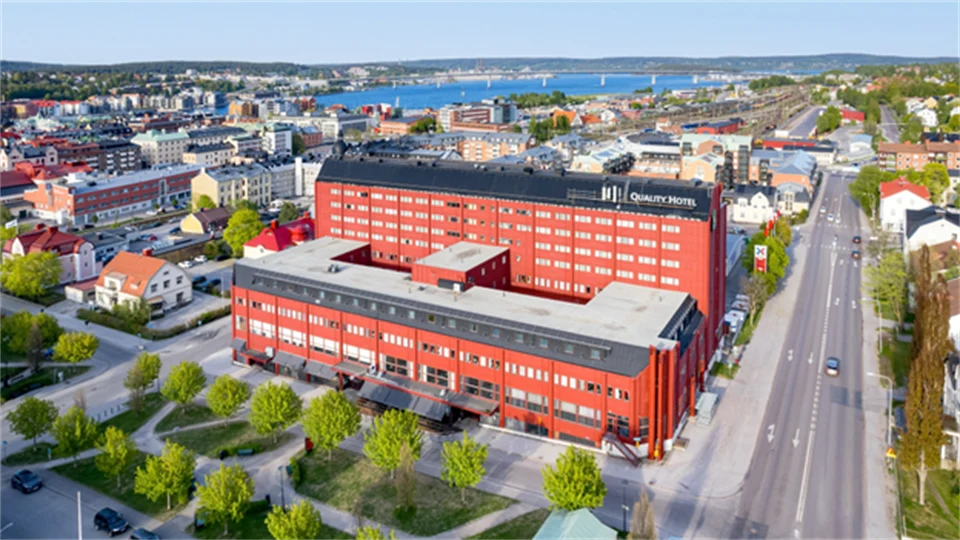 A red hotel building in an urban environment.