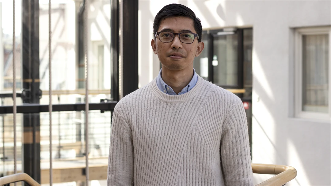 Man with glasses and dark hair.