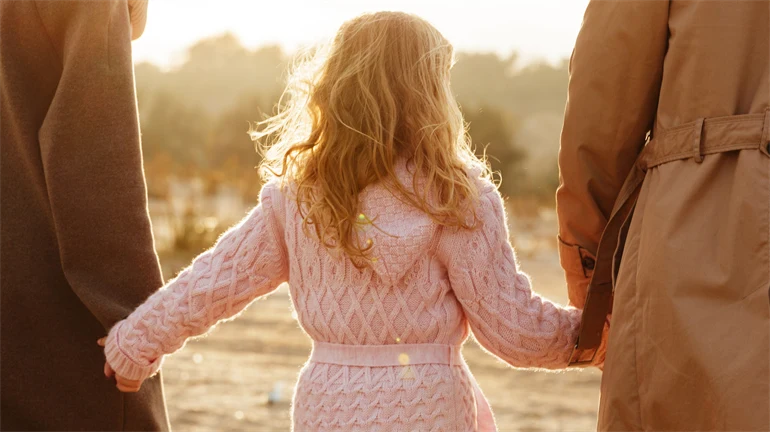 en kvinna, ett barn, en man, sedda bakifrån 