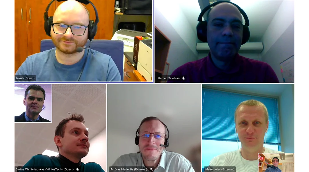 Group shot of seven men sitting in a Zoom meeting.
