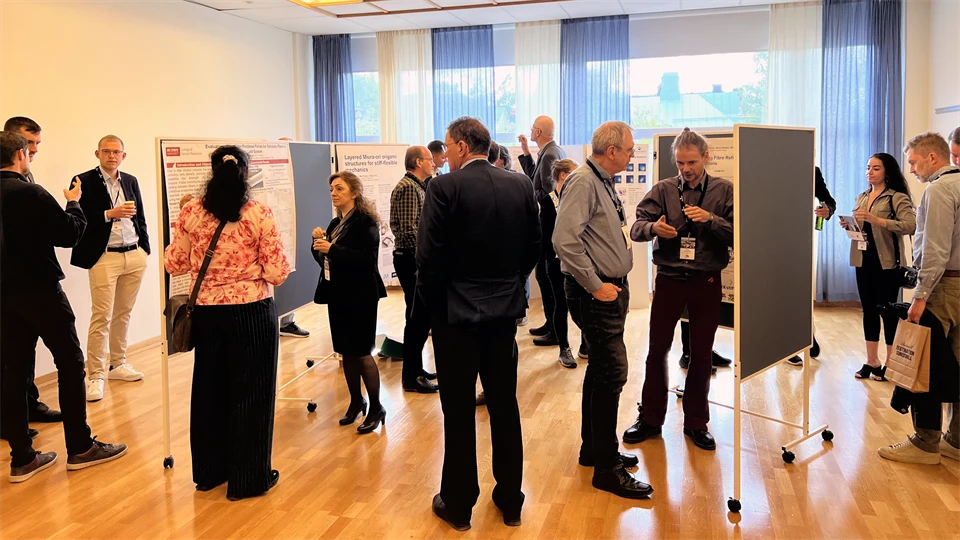 Men and women viewing research posters.