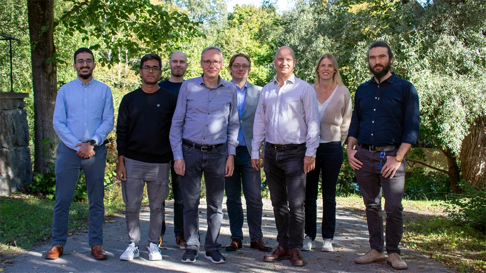 A group picture with eight people, one woman and the rest men.