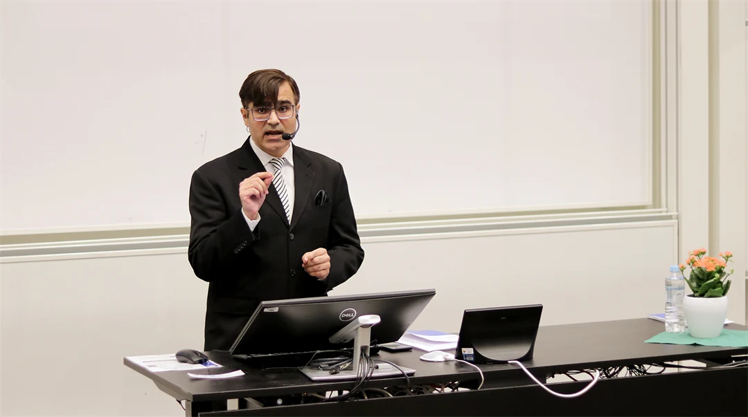 A man stands and lectures.