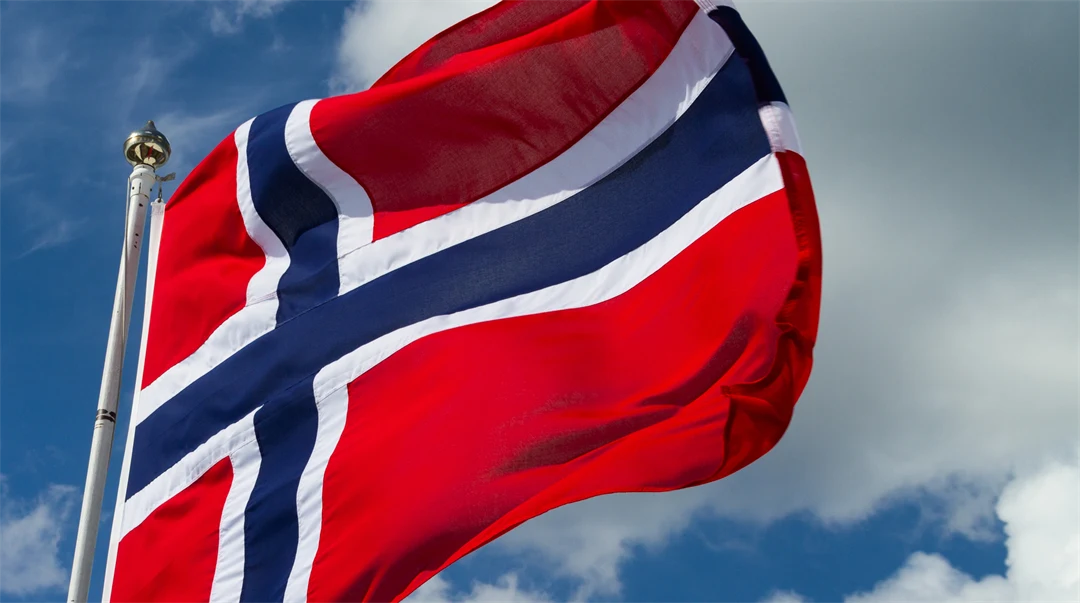 The Norwegian flag in front of a blue sky