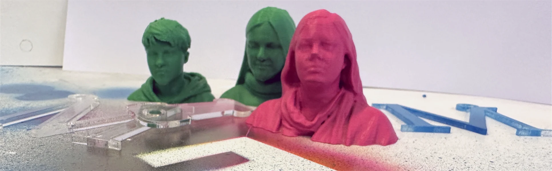three small heads in plastic
