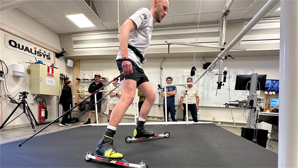 A man is roller-skiing on a treadmill.