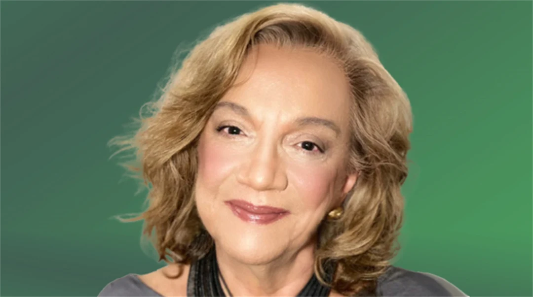  A portrait of a woman, against a green background.