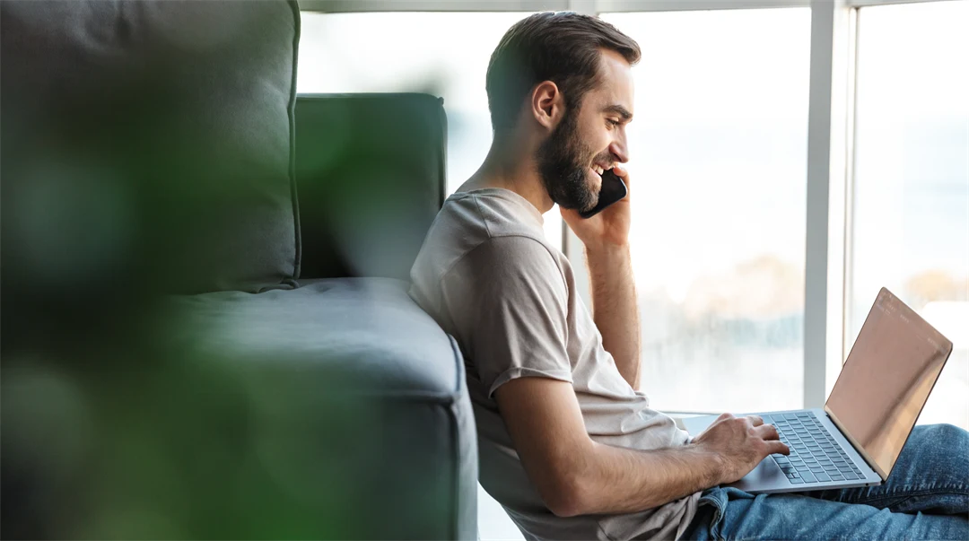 Young man with mobile and computer