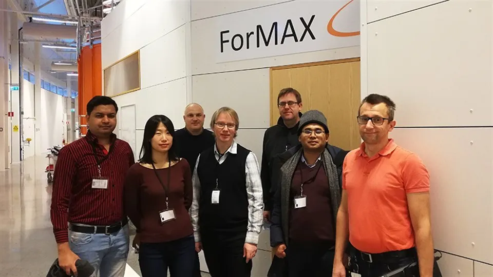 Group photo with researchers standing in front of a sign that says ForMAX.
