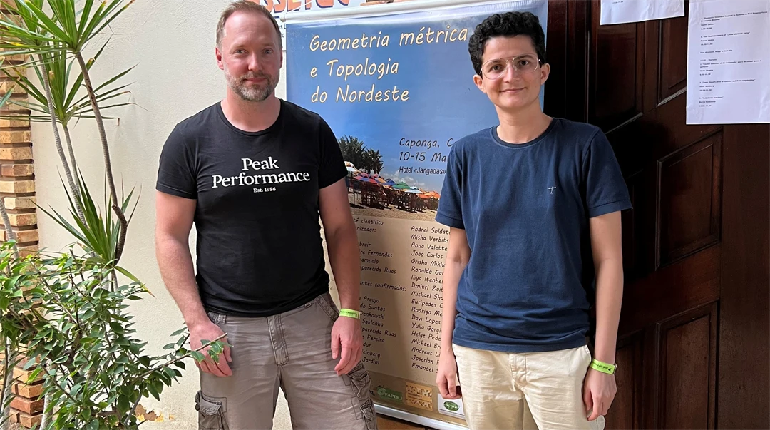  Two people are standing in front of a door.