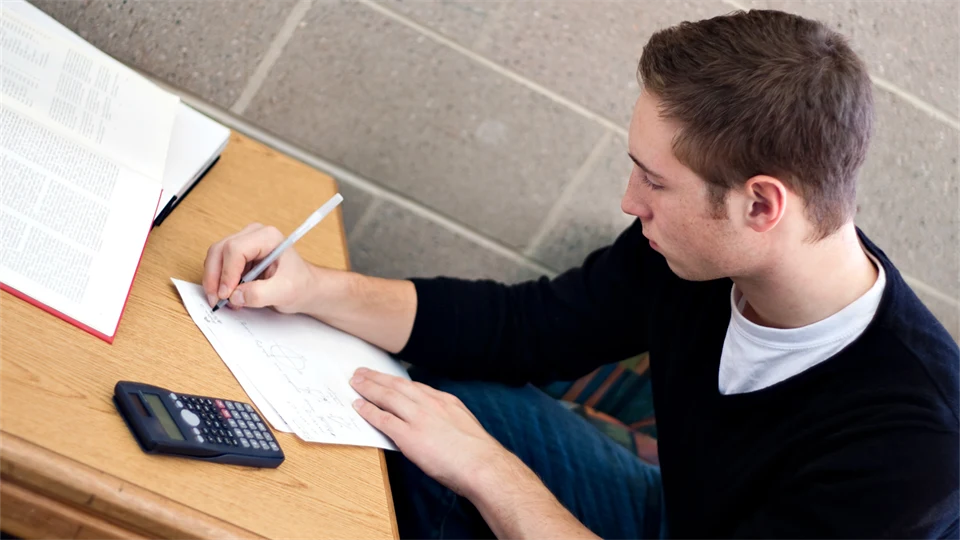 Student sitting and doing math.