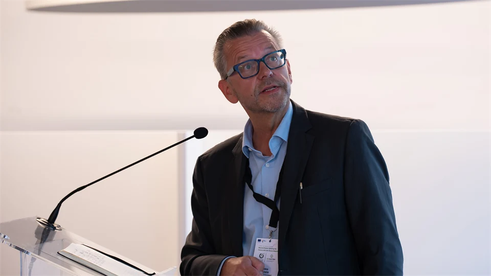 A man speaks into a small microphone.