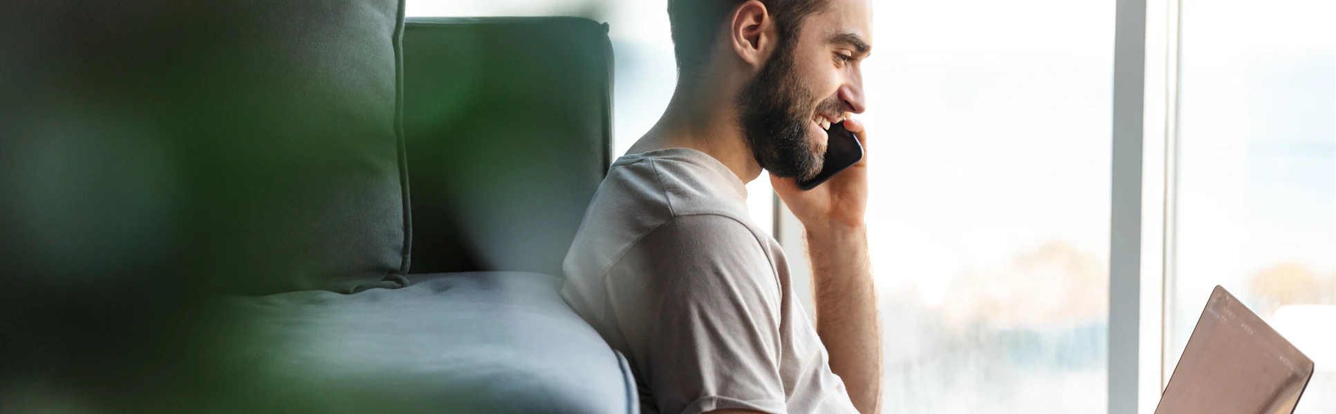 Young man with mobile and computer